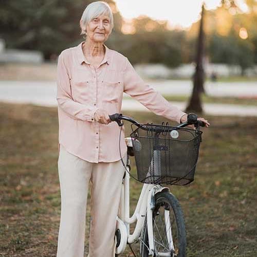 Senior Woman With Bicycle Min